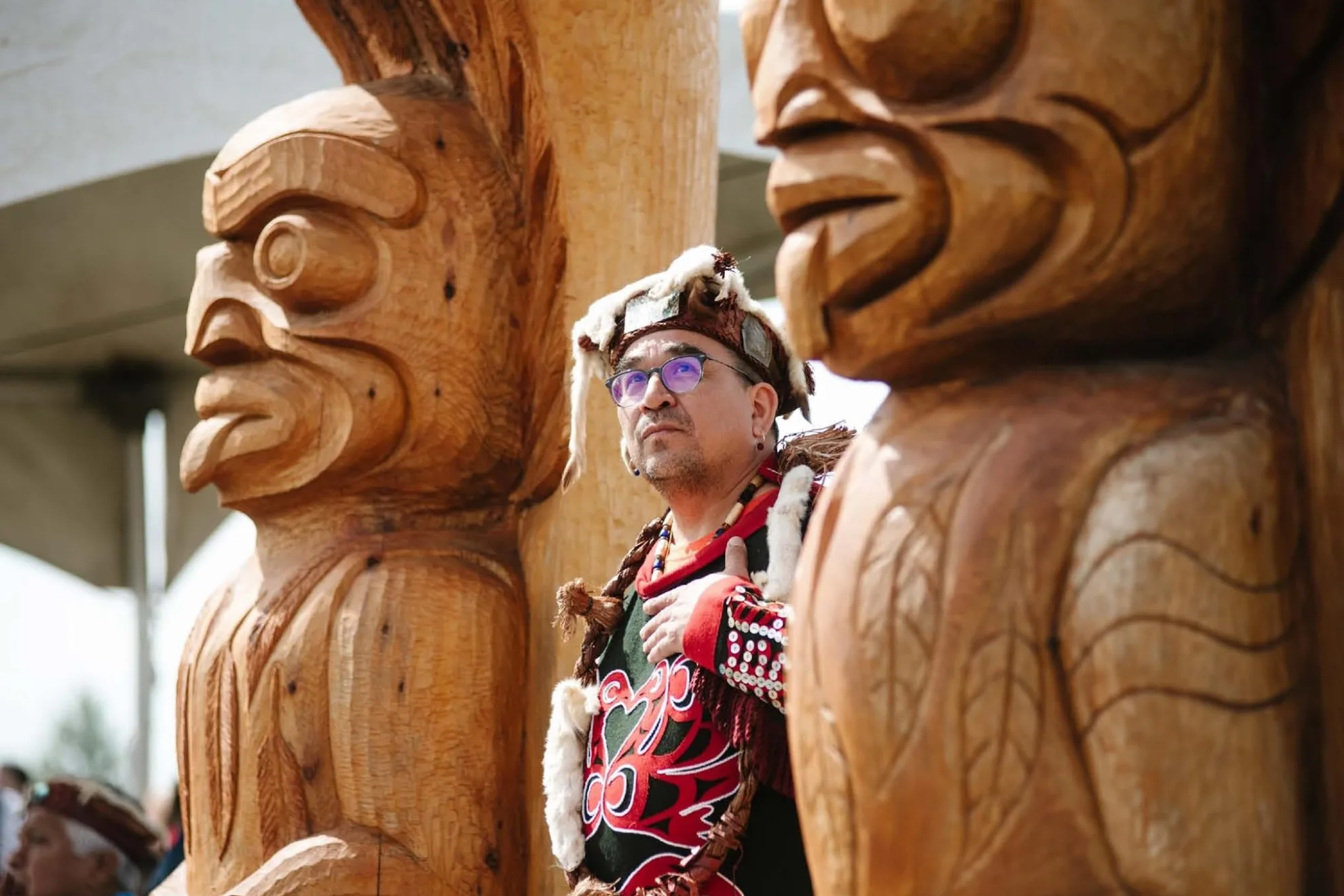 Wai Wai Kum Nation member with carved poles